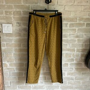 Anthropologie cropped pants with eyelet fabric and side embroidery.